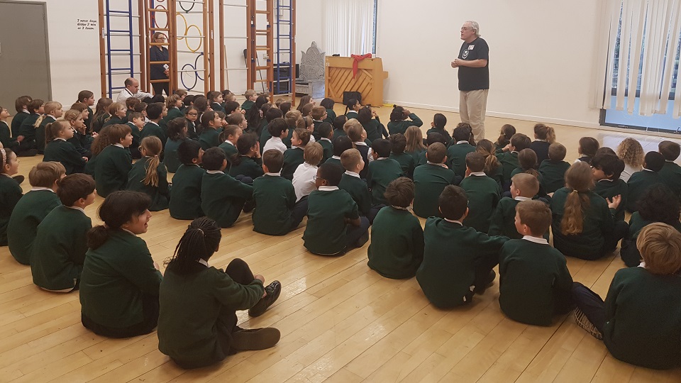 Emma Ballinger, vice-chair of the charity Porridge and Rice accepts a cheque from the school