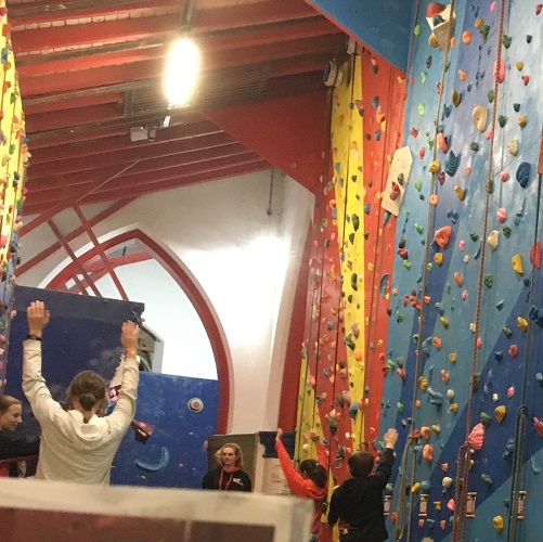 Joel climbs a wall at a local club for young people of all ages