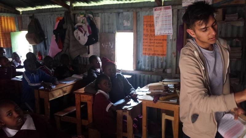 Jai, an A level student and volunteer with Porridge and Rice, teaches a maths class at a Porridge and Rice school in Ngando