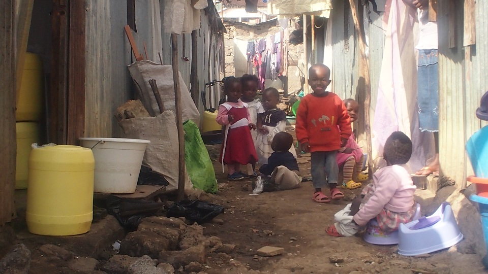 a street in the Nairobi slums of shacks that have no toilets, electricity or running water yet habited by whole families in a single room